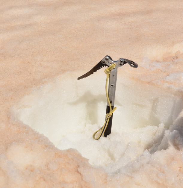 An ice axe in a snow pit